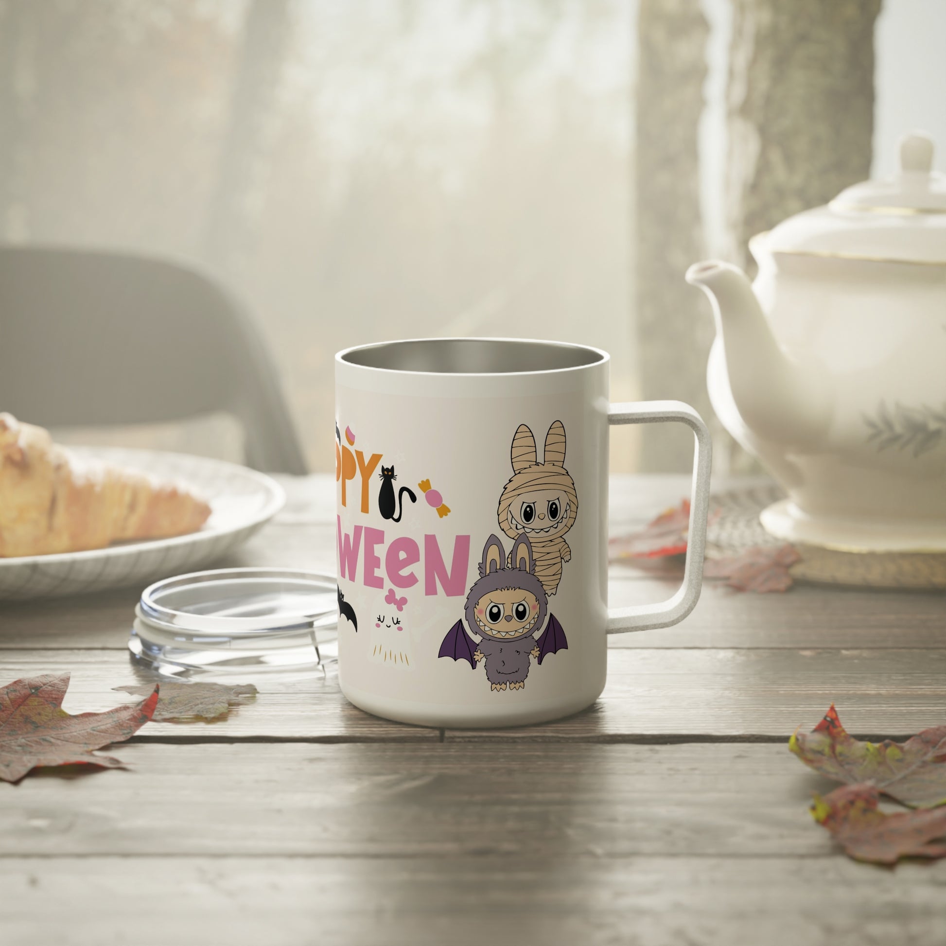 Happy Halloween coffee mug on cozy breakfast table, showing Labubu characters in costumes with autumn leaves around.