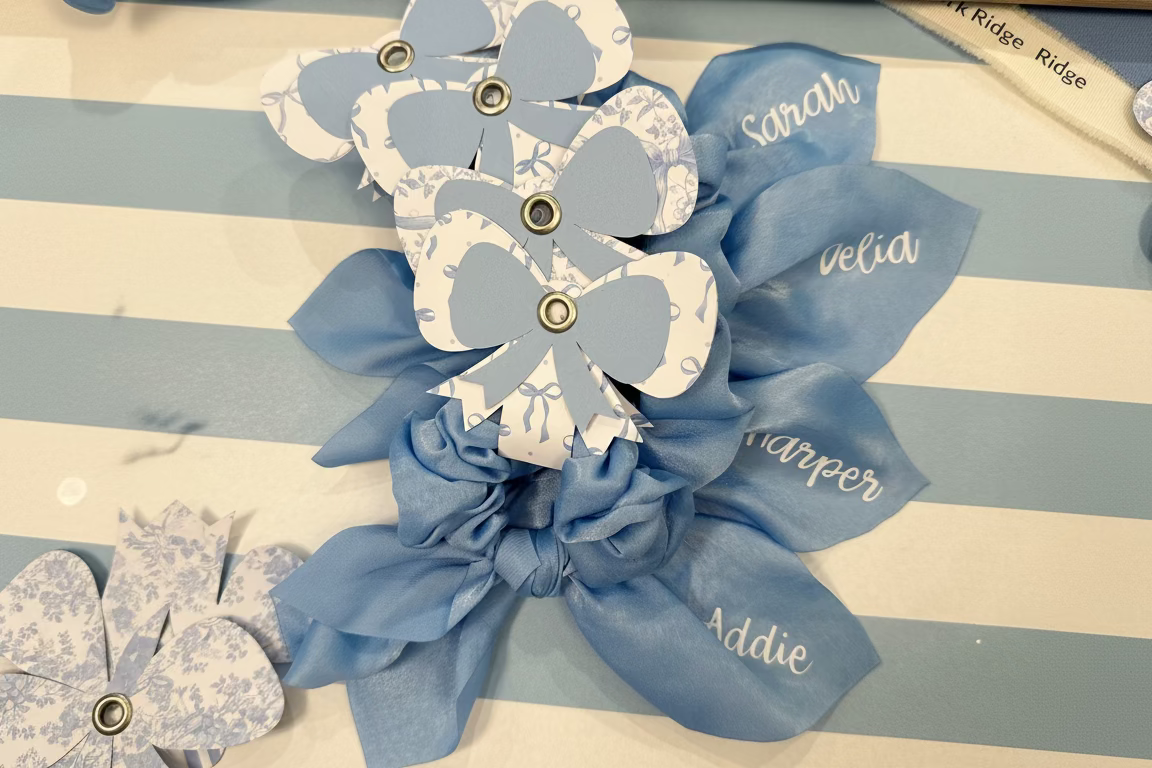 Blue decorative bows with names on a striped background